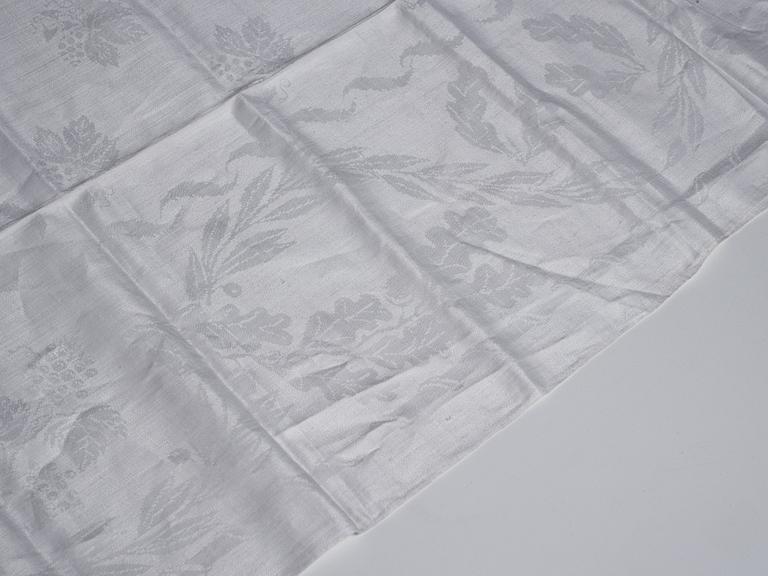 A tea table cloth, linen damask, "Lilla blomsterkorgen", ca 143,5 x 144 cm.