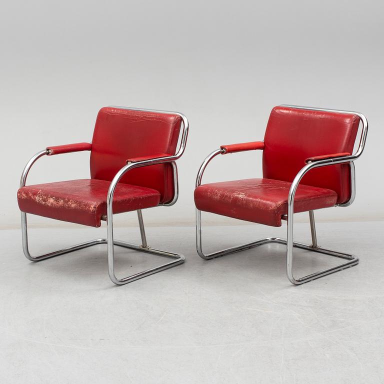 A pair of 1920s armchairs.