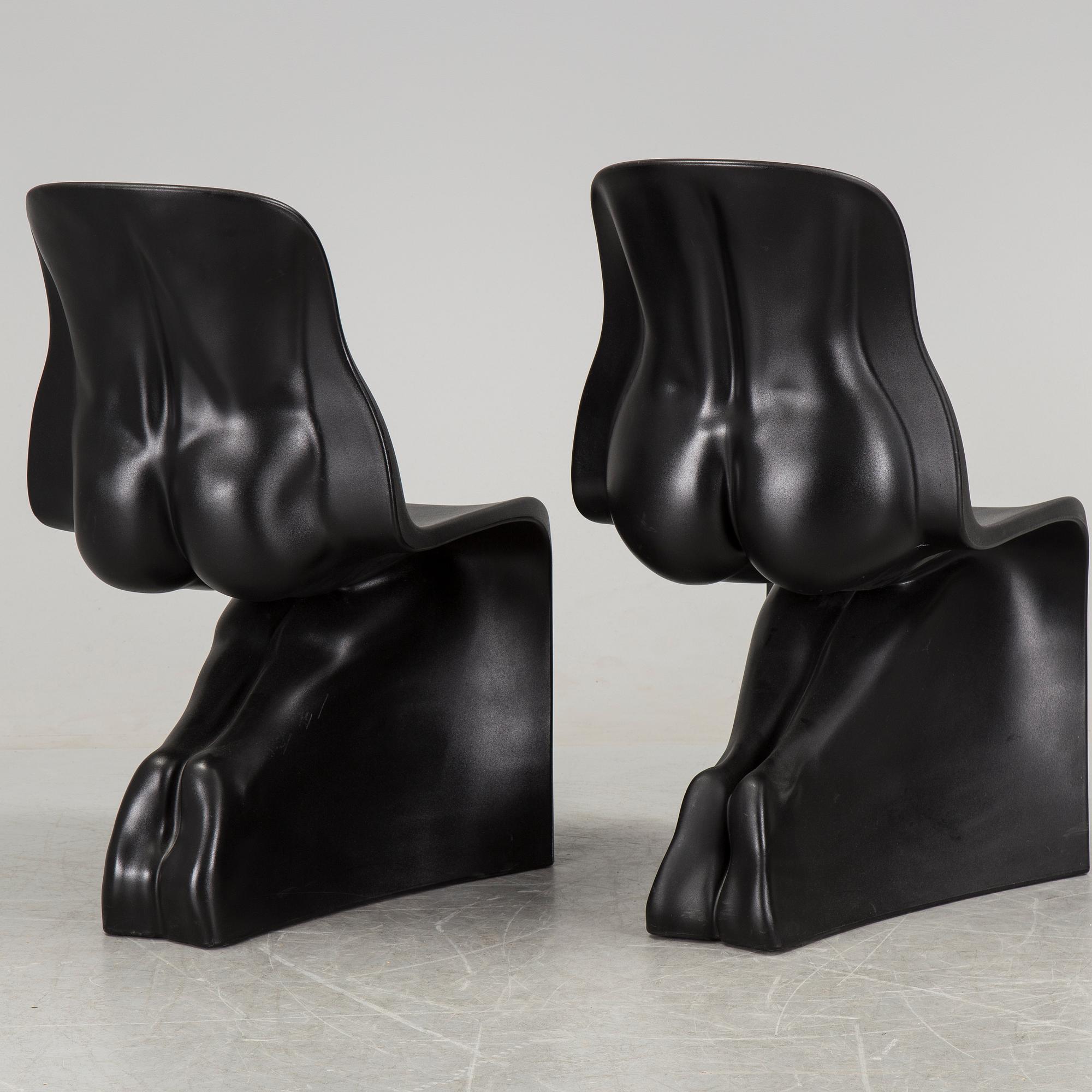 a pair of Italian black plastic chairs designed by Fabio Novembre "Him" and "Her" from the late 20th Century.