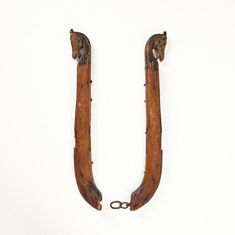 A pair of Swedish folk art carved and polychrome painted horse harness parts, Hälsingland, 18th century.