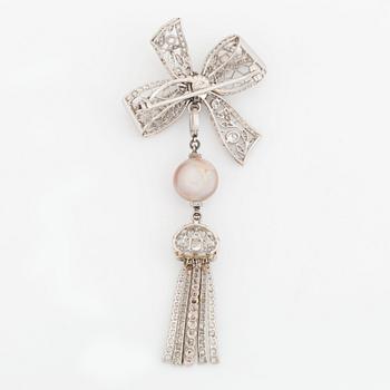 A platinum bow brooch set with old-cut diamonds with a detachable pearl and platinum pendant.