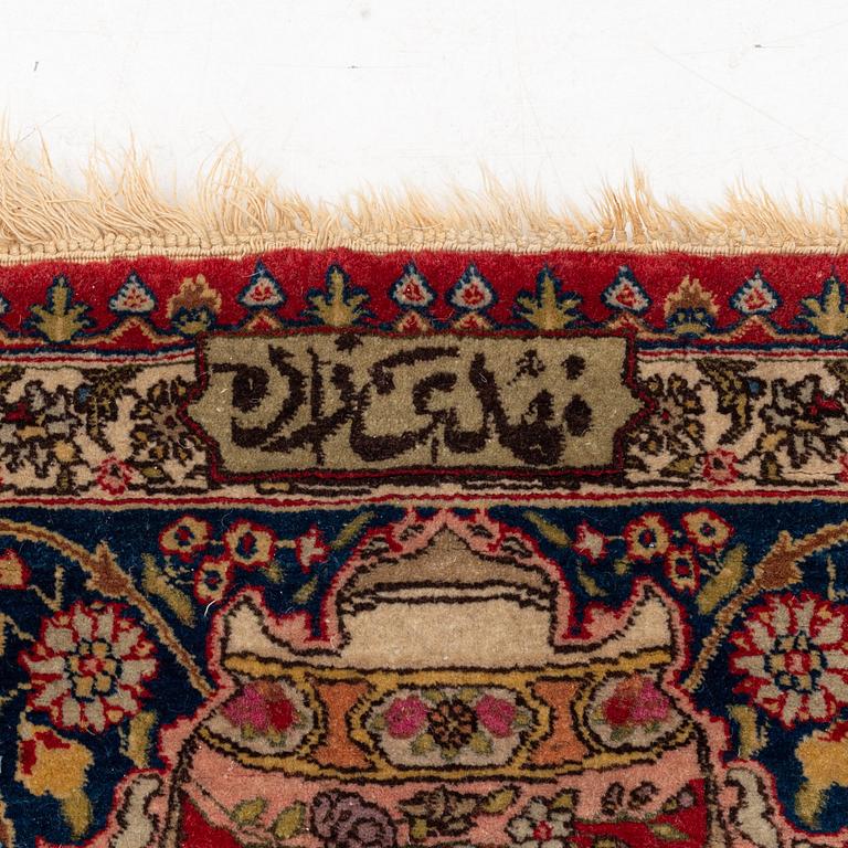 A signed semiantique pictoral Tabriz carpet, c. 269 x 189 cm.