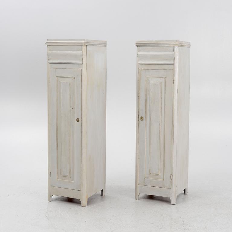 A pair of painted cabinets with a drawer.