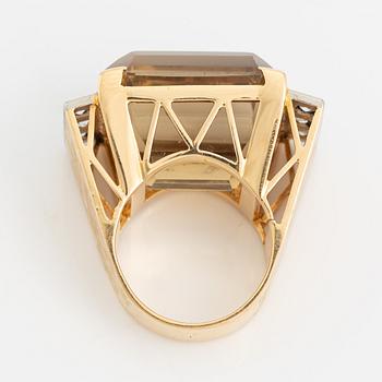 An 18K gold ring set with faceted quartz and old-cut diamons.