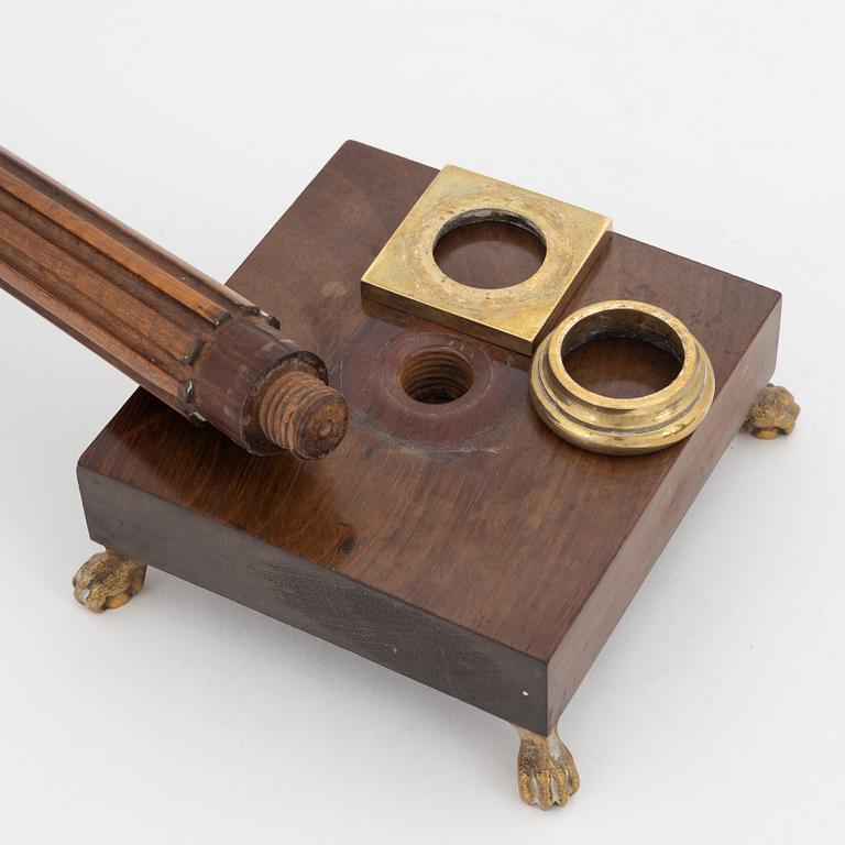 A pair of late Gustavian mahogany and brass candlesticks, circa 1800.