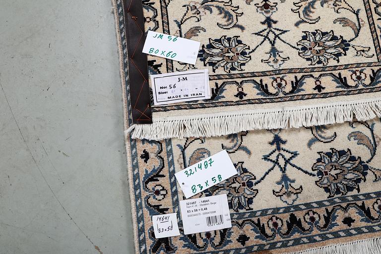 A pair of rugs, Nain, part silk, ca 80 x 60 cm 
 & ca 83 x 58 cm.