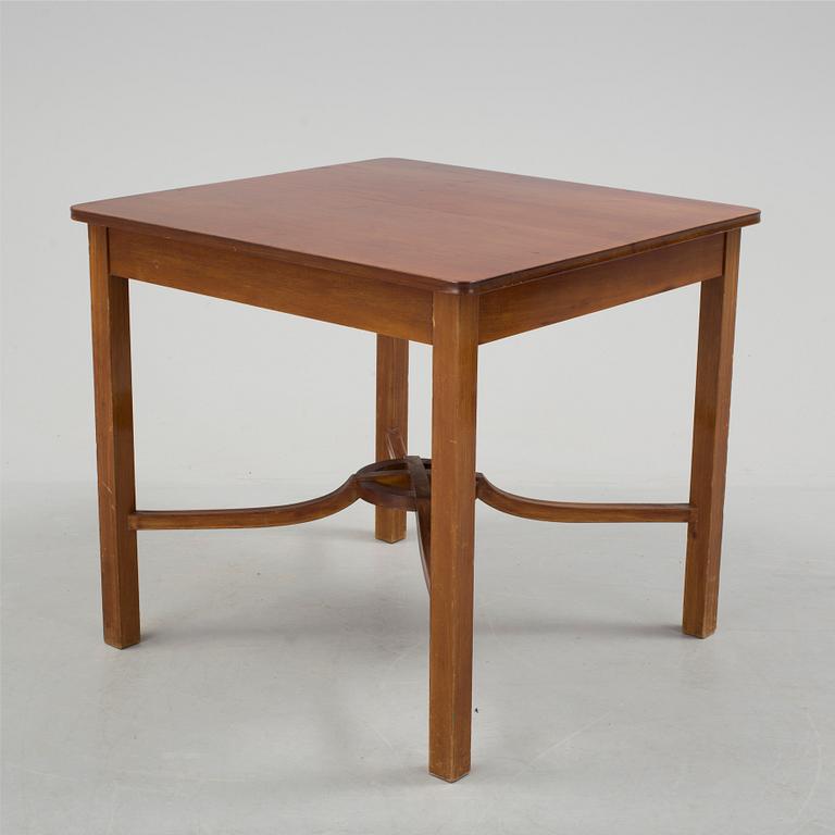 A mid 20th century mahogany veneered table from Nordiska Kompaniet (NK).