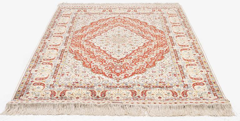 A semi-antique silk Hereke rug, West Anatolia, c. 180 x 121 cm.