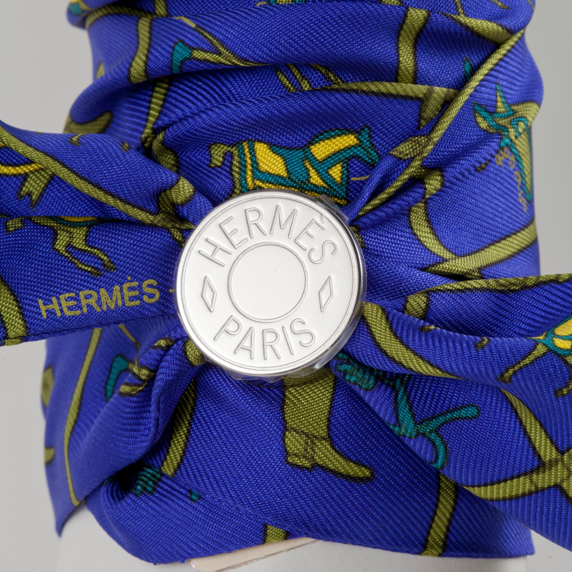 HERMÈS, two silk braclets with palladiumcovered locks.