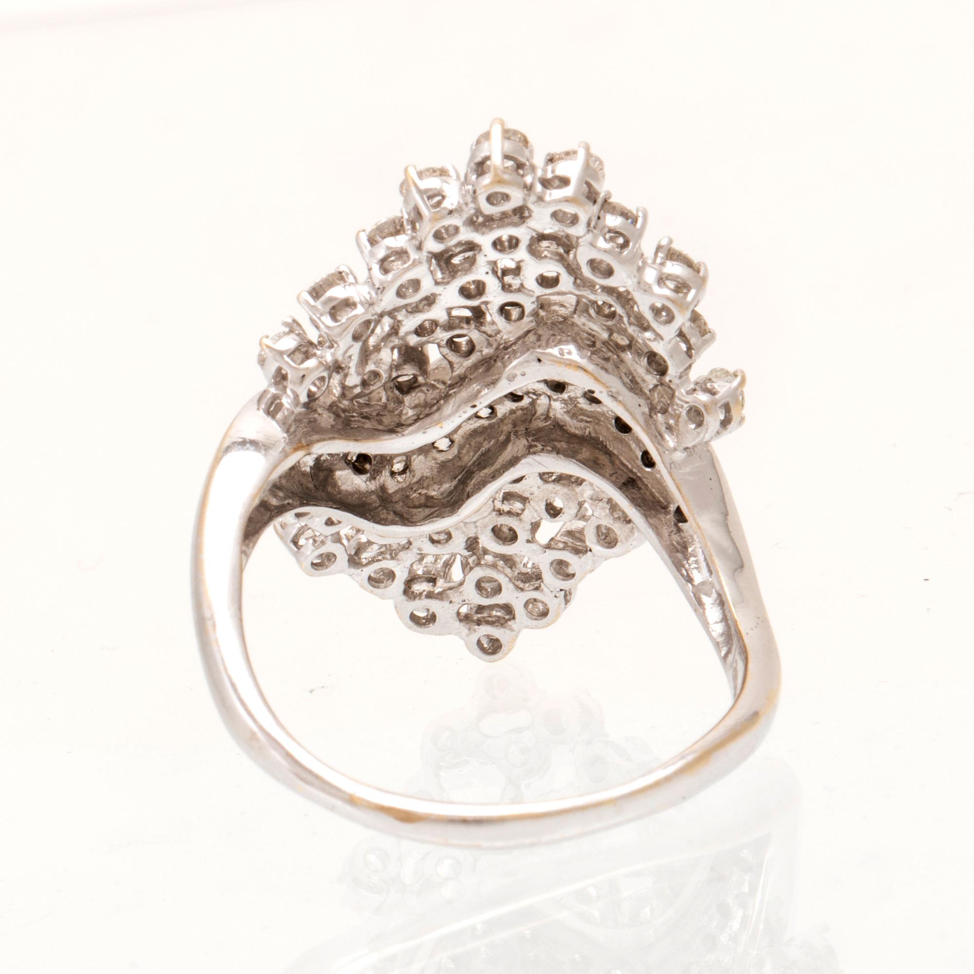 An 18K white gold ring set with round brilliant cut diamonds.