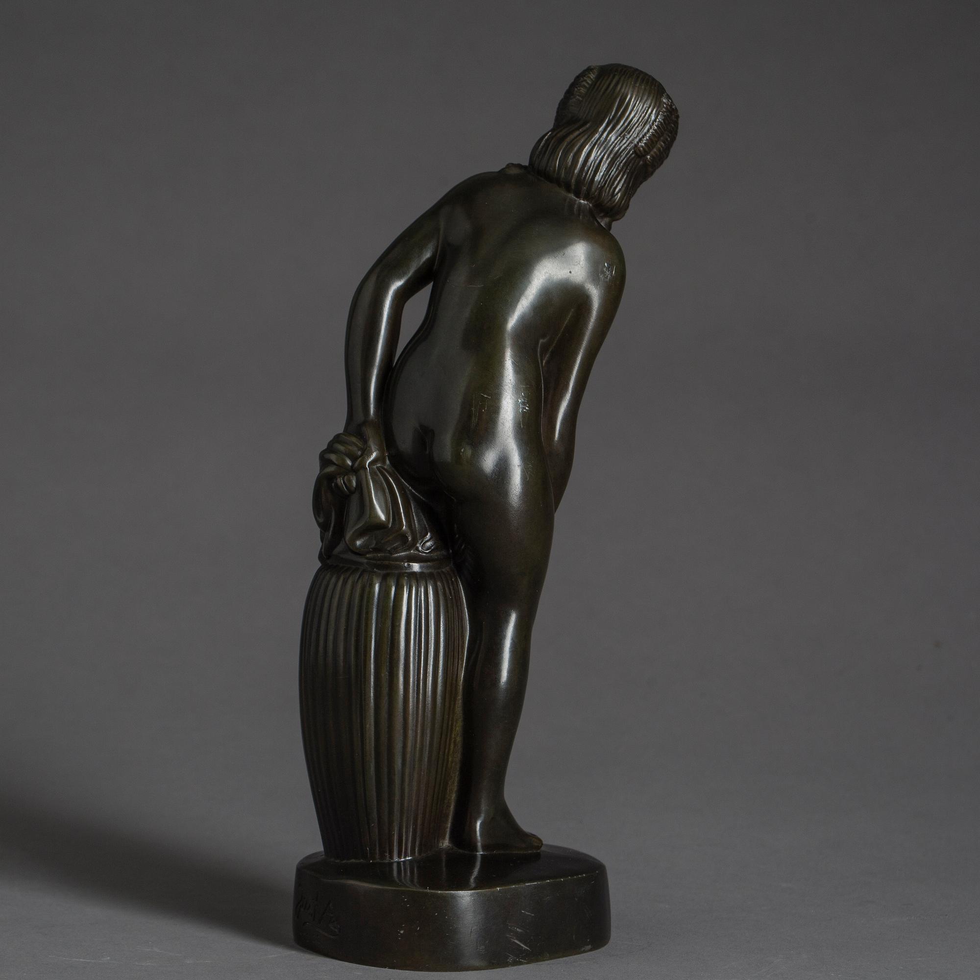 JUST ANDERSEN, a signed metal sculpture.