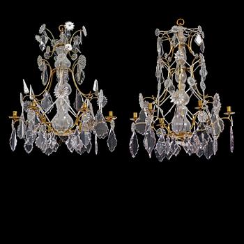 111. A near pair of rococo-style gilt brass and cut glass six-branch chandeliers, 19th century incorporating older elements.