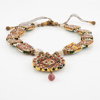An antique gold and enamel Qajar necklace with pearls set with turquoises and with a garnet drop.