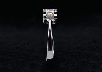 A RING, princess cut diamond 0.71 ct. H/vvs1 laserengraved ID no. GIA certifikat 18K white gold, weigth 5,1 g.