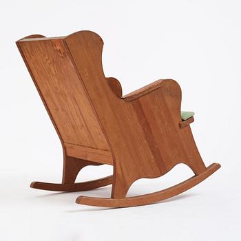 Nordiska Kompaniet, a Swedish Modern stained pine 'Lovö' rocking chair, 1940s.