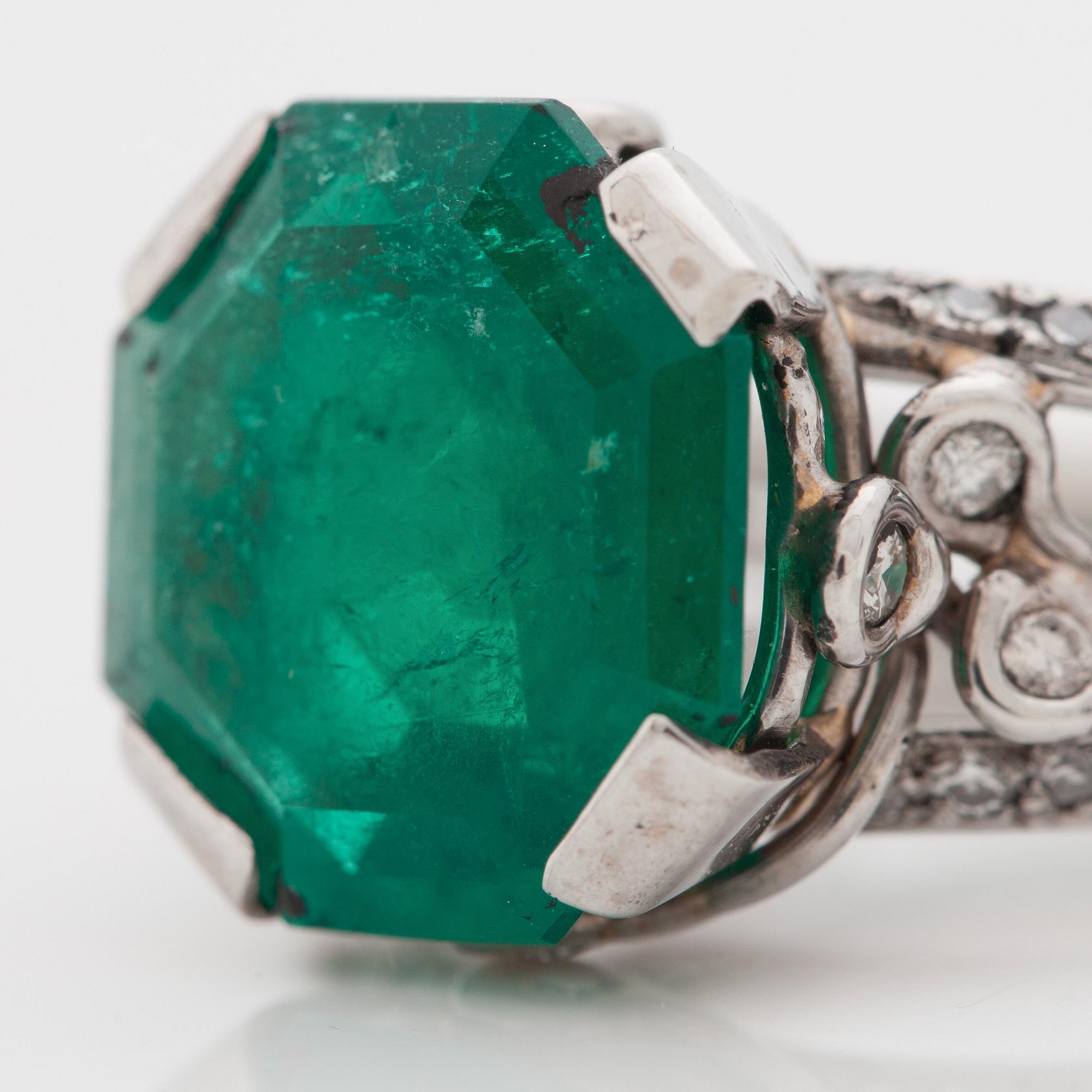 An octagonal cut 6.50 ct emerald and brilliant cut diamond ring. Mandelstam 'Ice Age'.