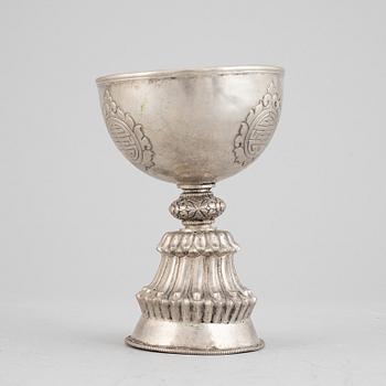 A Tibetan butter lamp, silvered copper, 20th century.