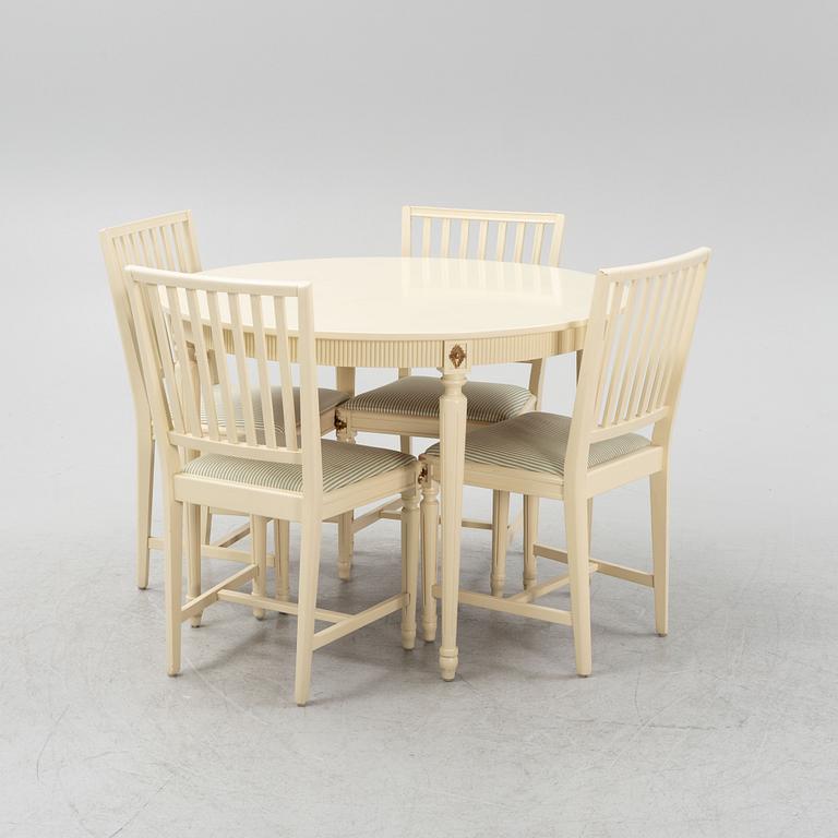A Gustavian style dining table with four chairs, second part of the 20th Century.