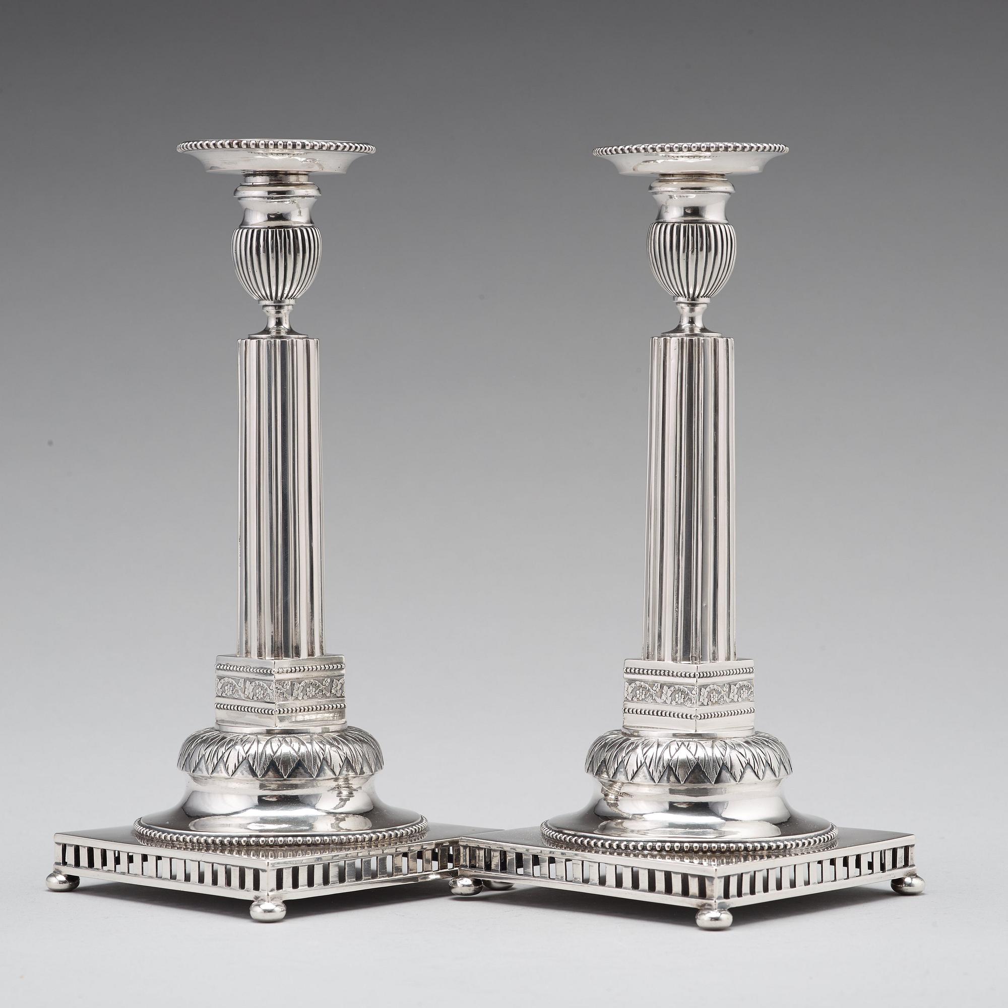 A pair of Swedish 18th century silver candlesticks, Stephan Westerstråhle, Stockholm 1793, one nozzle J E Torsk 1895.