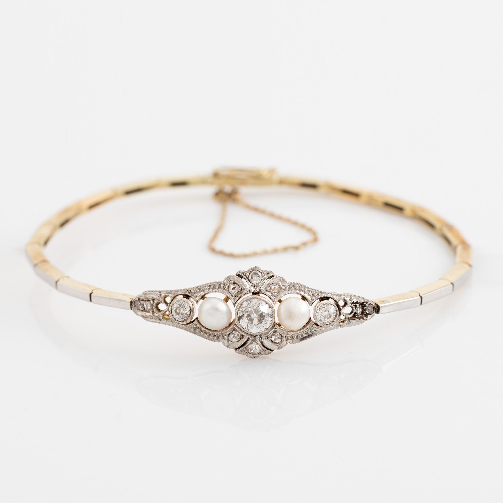 A 14K gold and platinum bracelet set with old- and rose-cut diamonds and pearls.