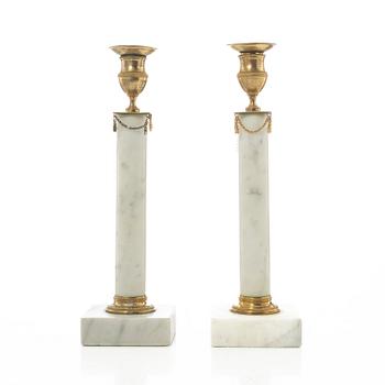 A pair of late Gustavian gilt brass and marble candlesticks, circa 1800.