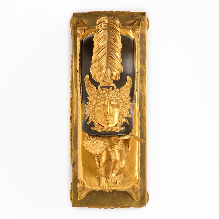A French Empire sculptural ormolu and patinated bronze mantel clock, early 19th century.
