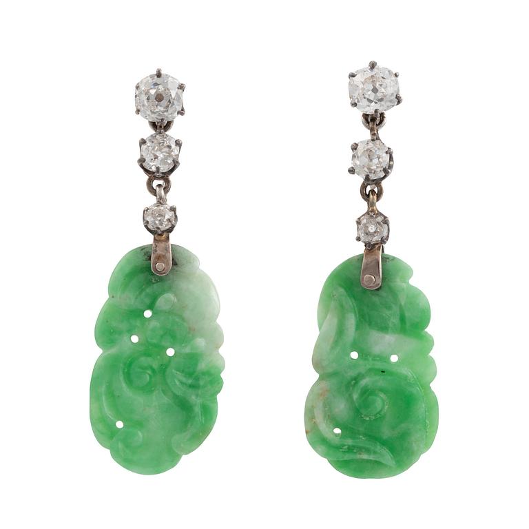 A pair of 18K white gold earrings with carved jadeite set with old-cut diamonds.