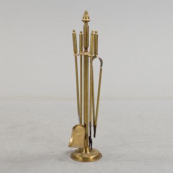 A set of 4 brass fire utensils with stand, 20th Century.