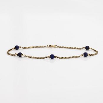 A 14K gold bracelet with lapis lazuli.