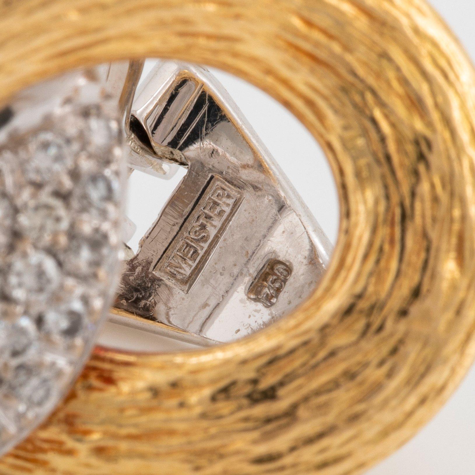 A pair of 18K gold and white gold Meister earrings set with round brilliant-cut diamonds.