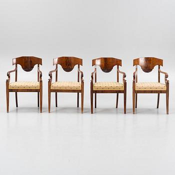 A suite of four Swedish Empire mahogany open armchairs, early 19th century.