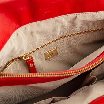 Diane von Fürstenberg a red leather handbag and wallet.
