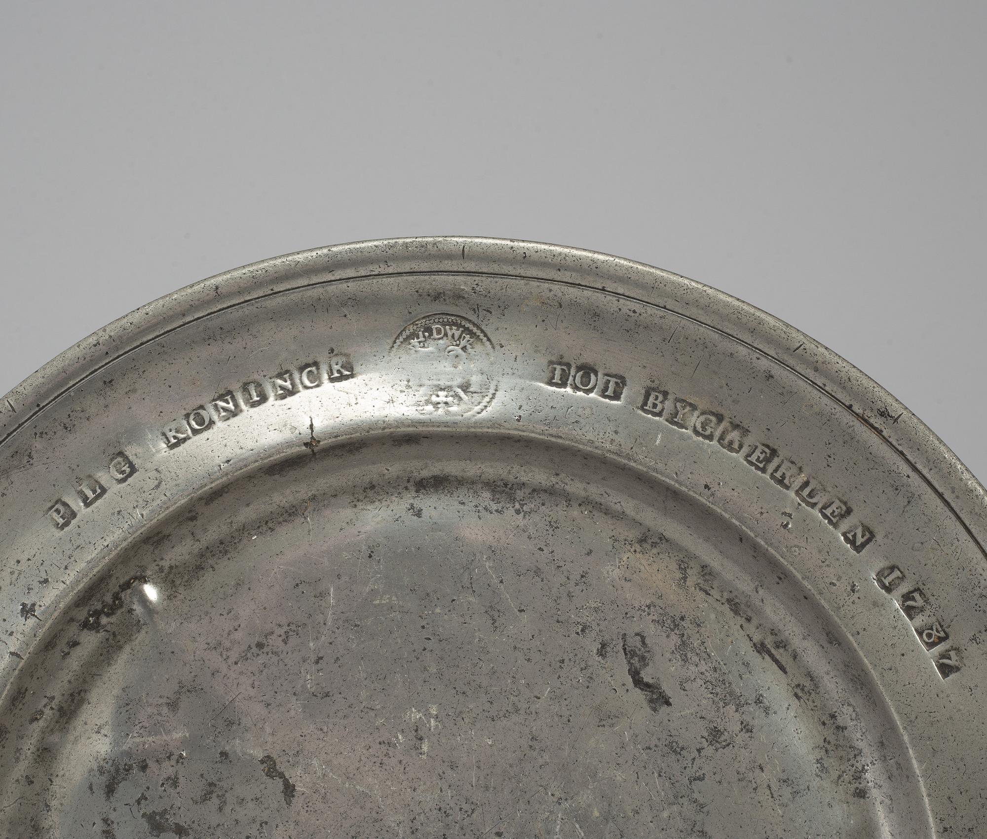 A pewter plate, dated 1787.