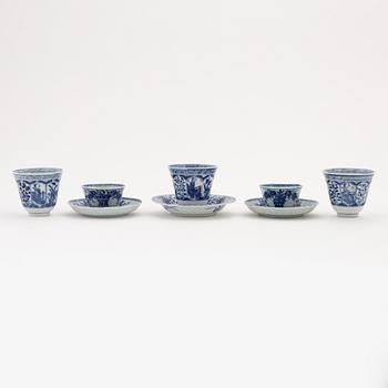 A pair of blue and white cups with saucers, three cups and a saucer, Qing dynasty, Kangxi (1662-1722).