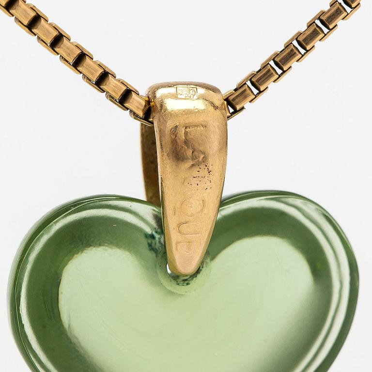 A Lalique heart pendant with an 18K gold chain.