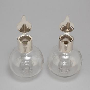 A pair of caraffes with silver mountings by CG Hallberg, Stockholm 1890.