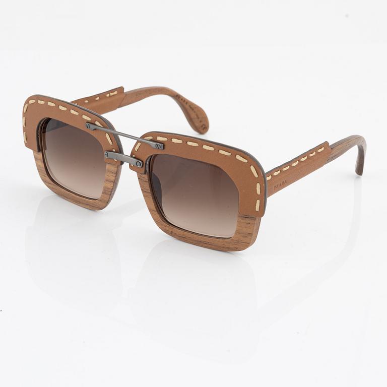 Prada, a pair of wood and leather sunglasses.