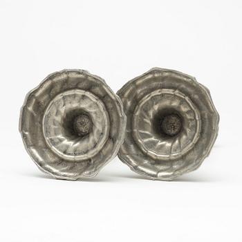 A pair of Swedish Rococo pewter candlesticks by L Lundwall 1762.