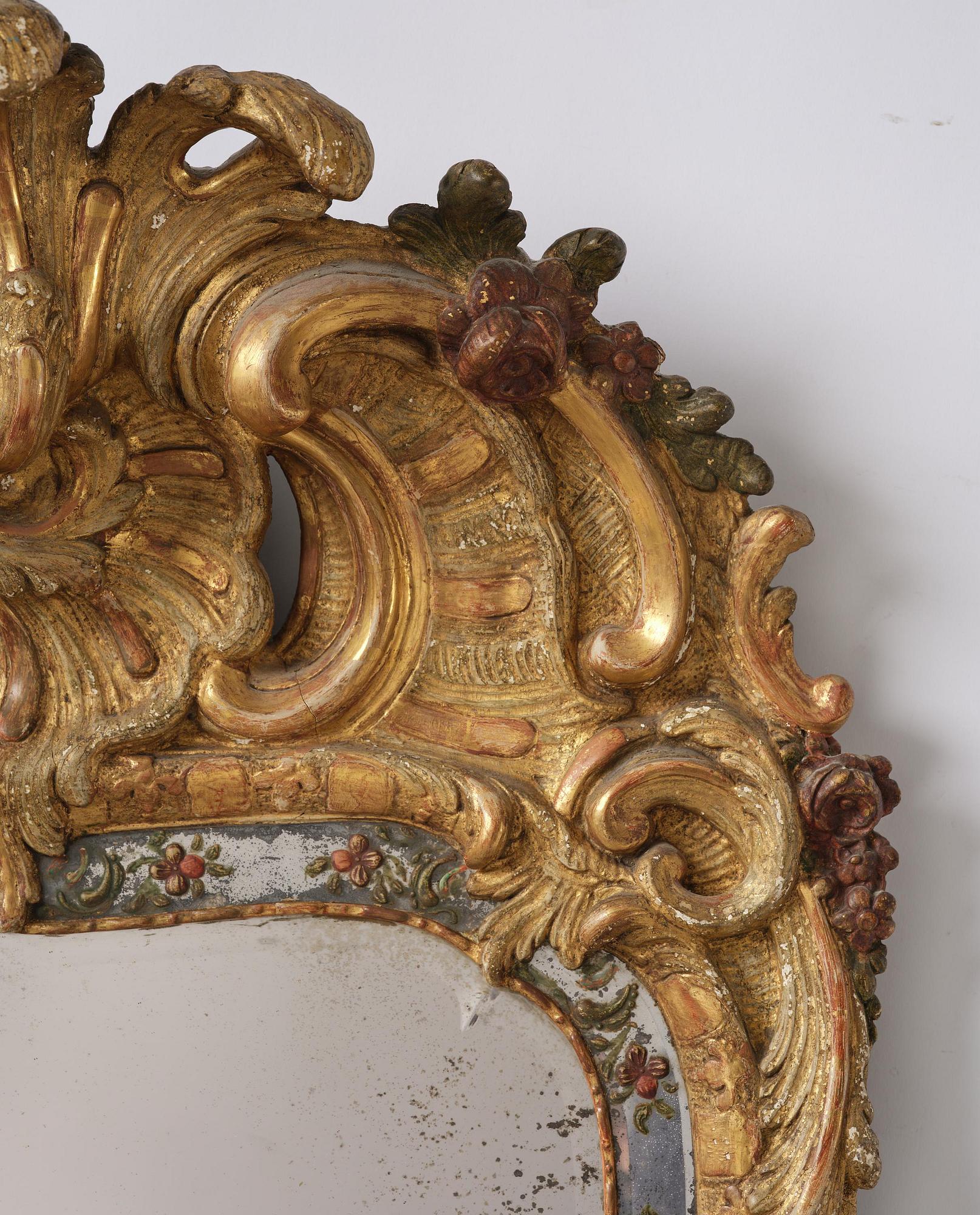 A Swedish giltwood and polychrome-painted Rococo mirror, later part of the 18th century.