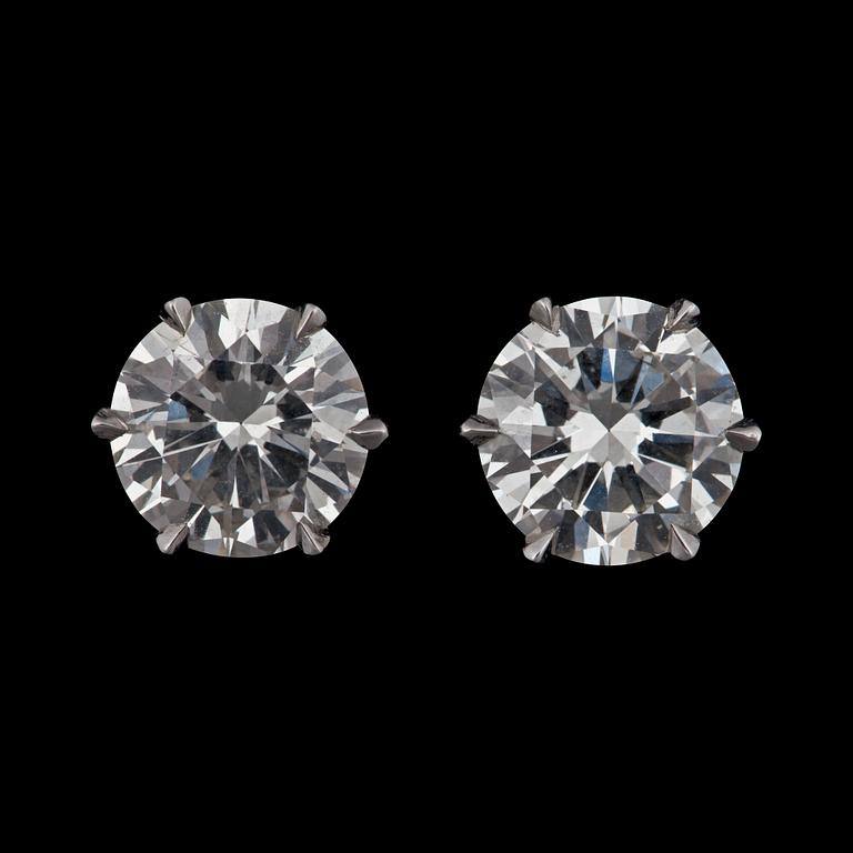 A pair of diamond earrings. Total carat weight 3.38 cts.