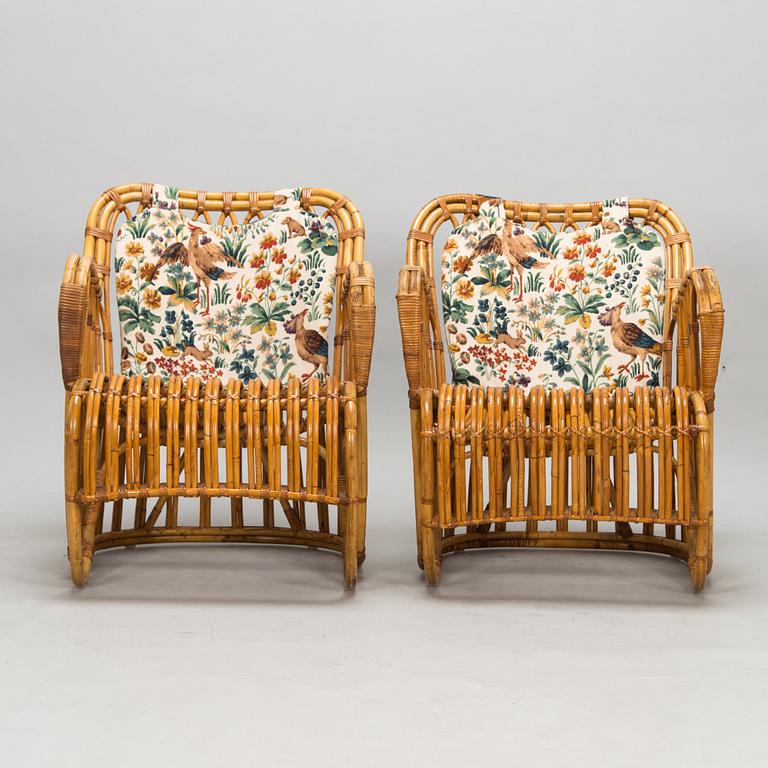 A pair of mid-20th-century rattan armchairs.