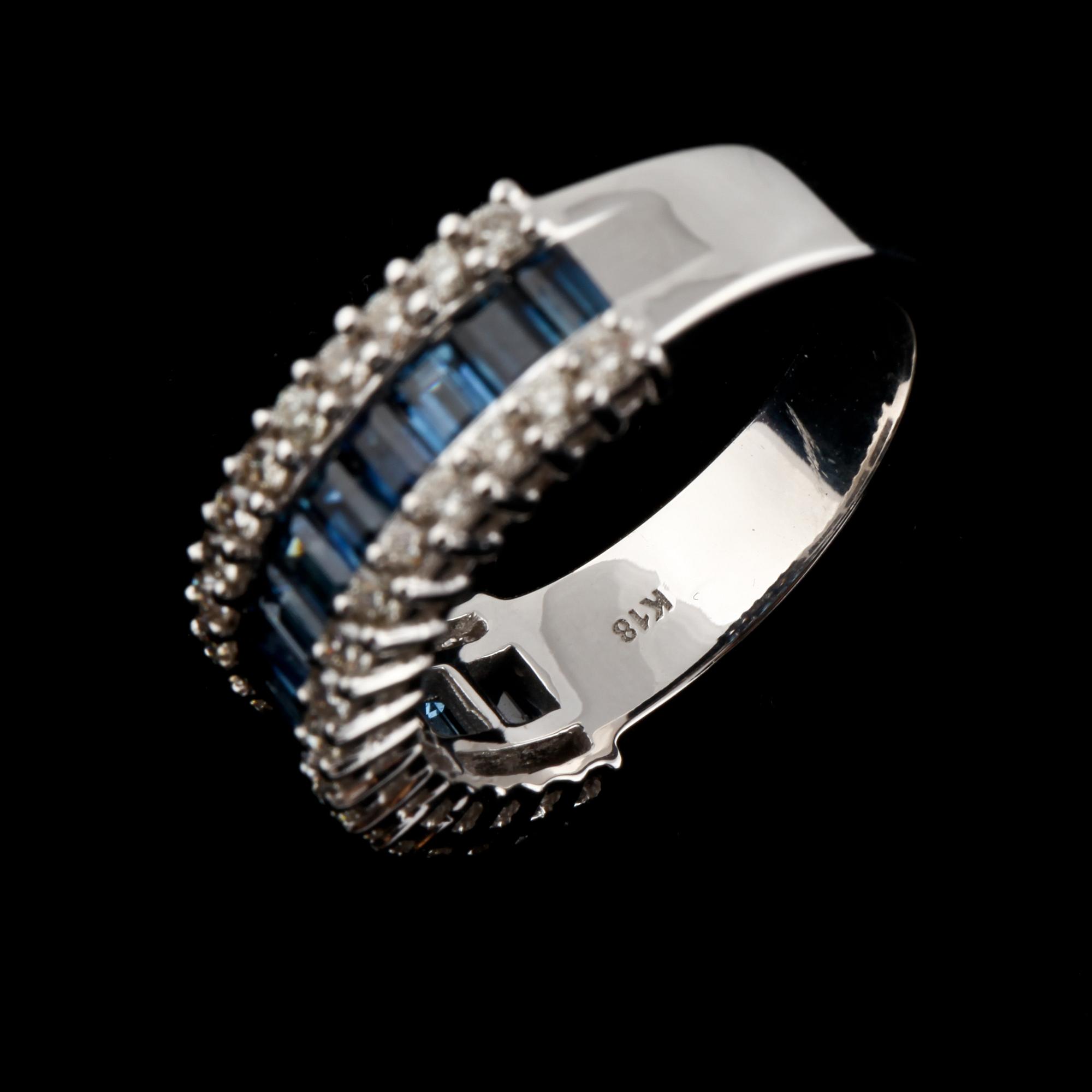 RING, 18k vitguld med 34 briljantslipade diamanter, ca 0.64 ct samt 15 blå safirer, ca 1.54 ct. Vikt 7 g.