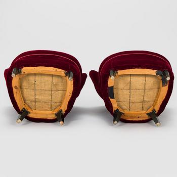 A pair of mid-20th century armchairs.