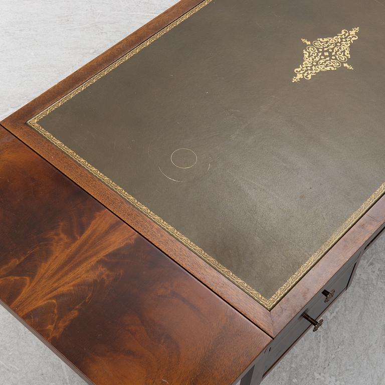 A mahogany veneer desk with desk chair, 20th Century.