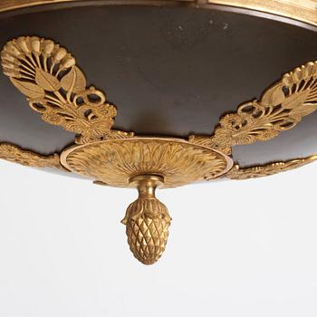 An Empire.style five-branch patinated and gilt bronze chandelier, later part of the 19th century.