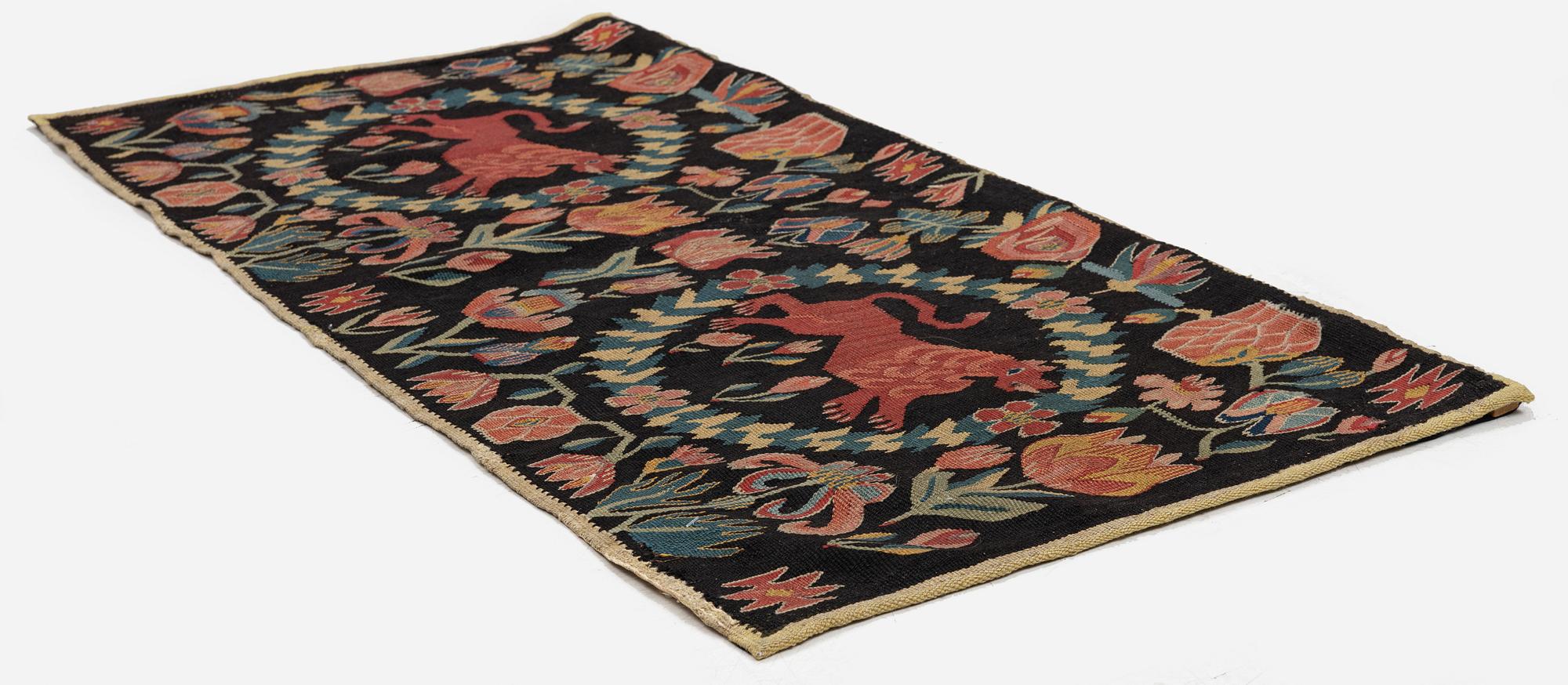 A cushion, 'Red Lion' (Rött Lejon), tapestry weave, c. 98 x 49 cm, Southwestern Scania, first part of the 19th century.