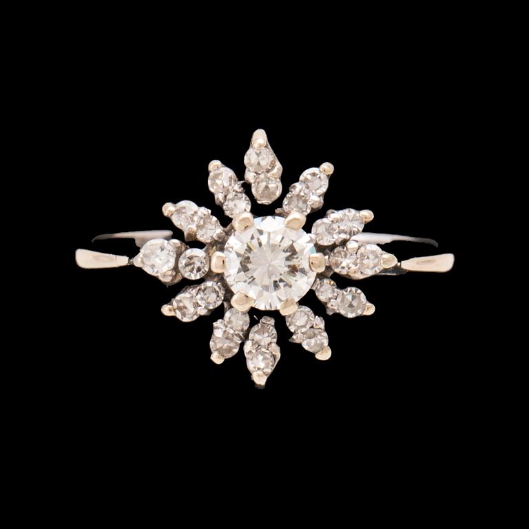 An 18K white gold ring set with round brilliant-cut and round single-cut diamonds.