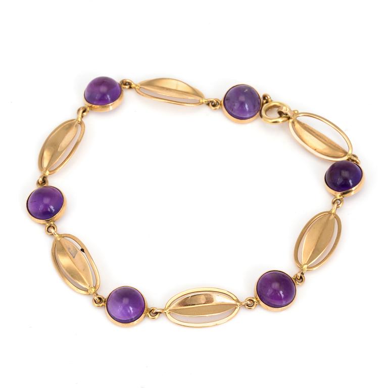 A bracelet with round, cabochon-cut amethysts.