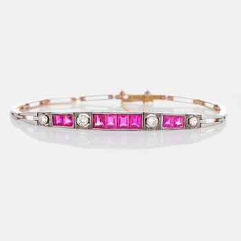 1104. An 18K gold and platinum bracelet set with step-cut rubies and old- and rose-cut diamonds.