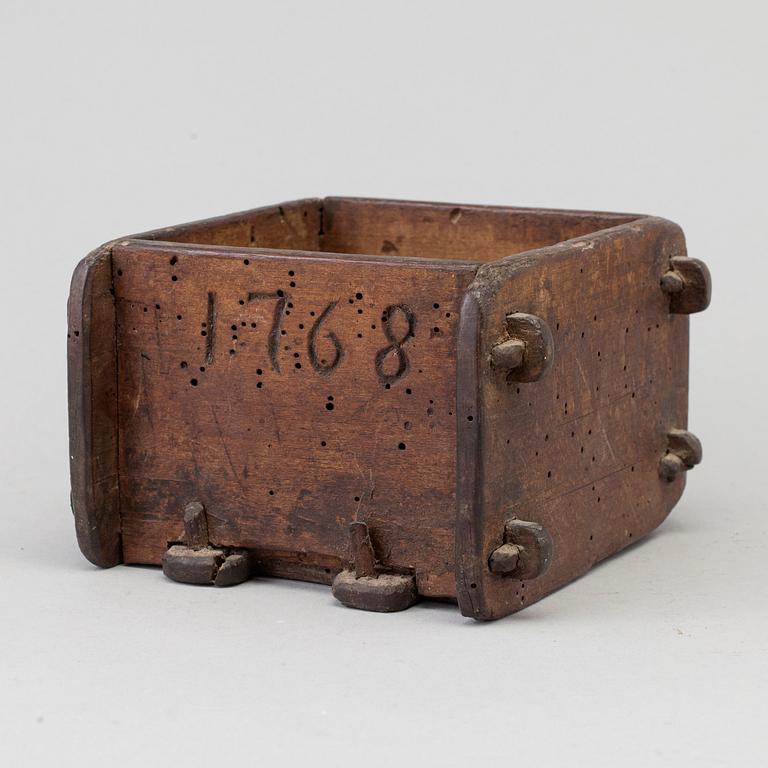 A cheese mould, dated 1768.